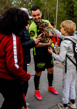 Niklas Castro of Brann with a dog