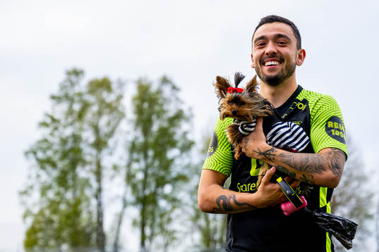 Niklas Castro of Brann with a dog