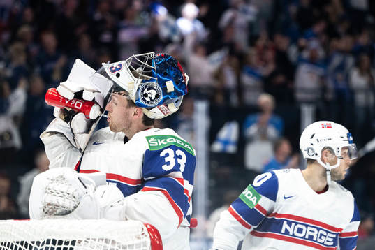 Goaltender Henrik Haukeland of Norway looks dejected