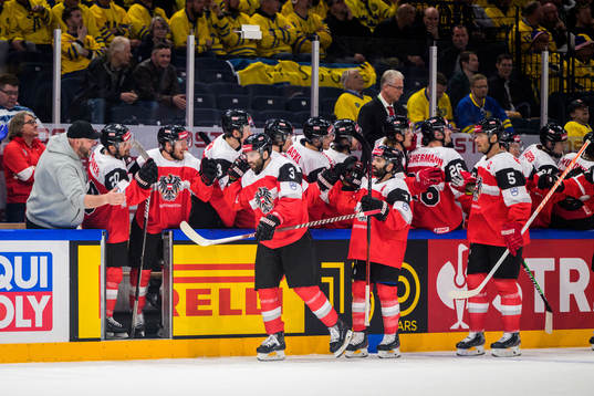 Peter Schneider of Austria celebrate with teammates