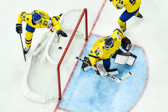 Oliver Ekman Larsson and goaltender Marcus Högberg of