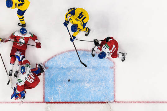 Rasmus Asplund of Sweden scores 1-1 behind goaltender Karel