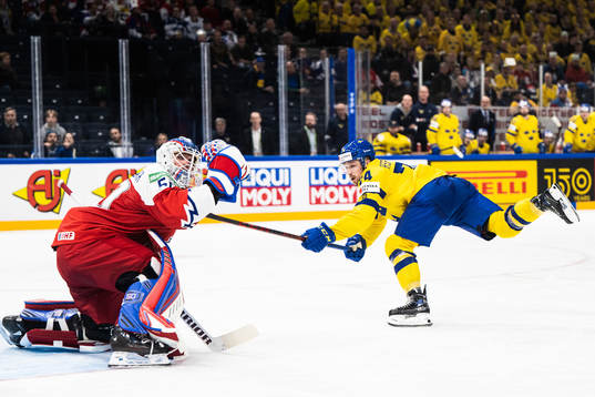 Rasmus Asplund of Sweden scores 1-4 behind goaltender Karel