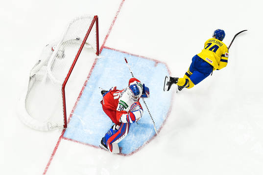 Rasmus Asplund of Sweden scores 1-4 behind goaltender Karel