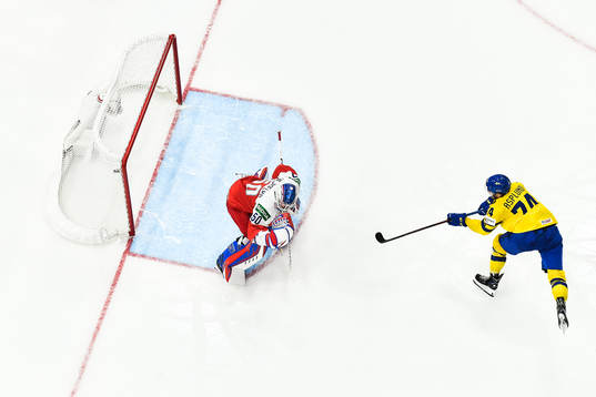 Rasmus Asplund of Sweden scores 1-4 behind goaltender Karel