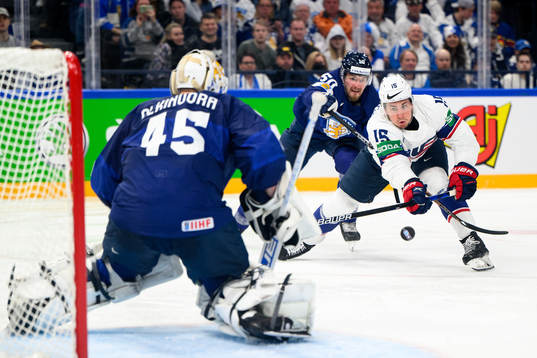 John Hayden of USA against goaltender Juho Olkinuora of