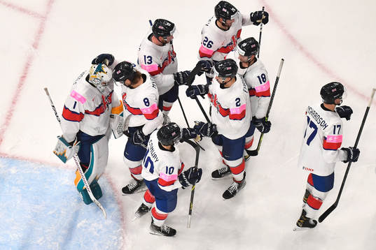 Goaltender Jackson Whistle of Great Britain with teammates