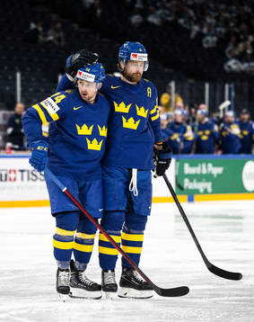 Rasmus Asplund and Adam Larsson of Sweden celebrate the 1-0