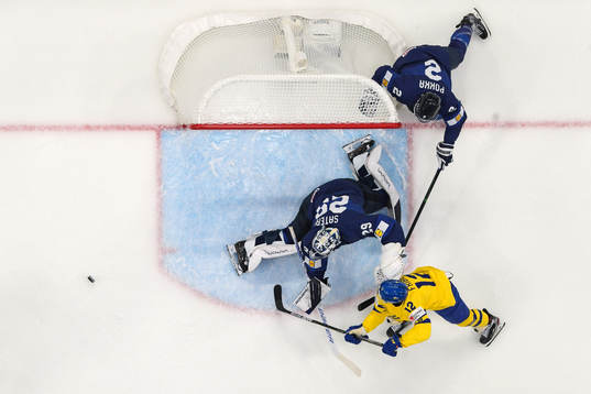 Max Friberg of Sweden against Ville Pokka and goaltender
