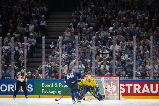 Sakari Manninen of Finland against goaltender Magnus