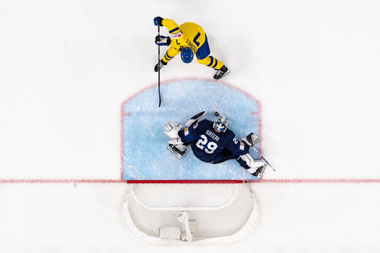 Henrik Tömmernes of Sweden and goaltender harri Säteri of