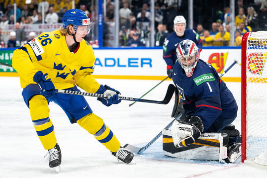Rasmus Dahlin of Sweden and goaltender Jeremy Swayman of USA