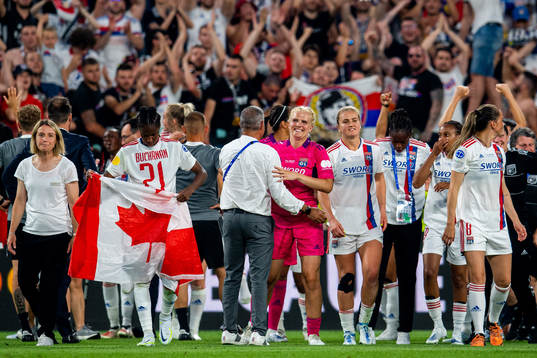 Goalkeeper Emma Holmgren of Lyon celebrates winning the