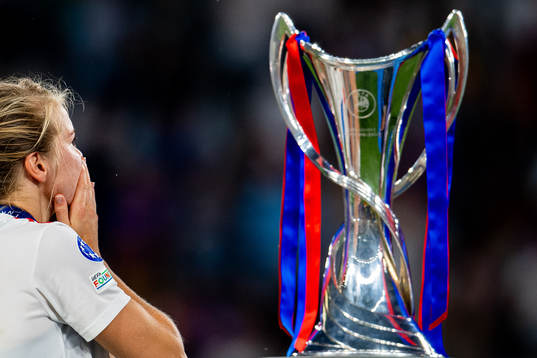 Ada Hegerberg of Lyon walks past the winners trophy