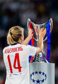 Ada Hegerberg of Lyon walks past the winners trophy