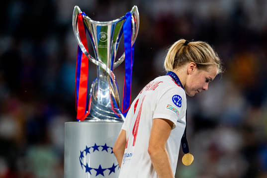 Ada Hegerberg of Lyon walks past the winners trophy