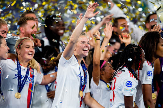 Ada Hegerberg and players of Lyon celebrate winning the