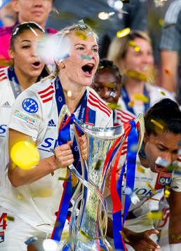 Ada Hegerberg of Lyon lifts the winners trophy