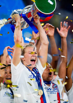 Ada Hegerberg of Lyon lifts the winners trophy