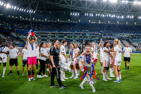 Ada Hegerberg of Lyon celebrates with the winners trophy
