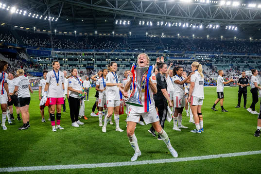 Ada Hegerberg of Lyon celebrates with the winners trophy