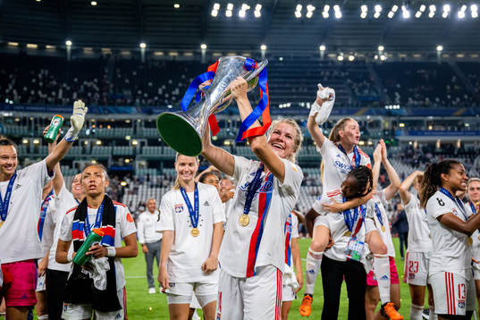 Ada Hegerberg of Lyon celebrates with the winners trophy