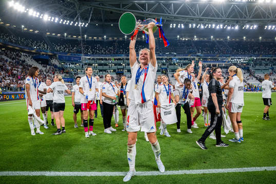 Ada Hegerberg of Lyon celebrates with the winners trophy