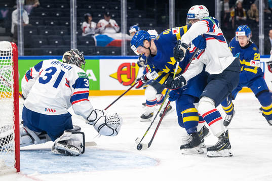 Goaltender Jonas Arntzen of Norway and Carl Klingberg of