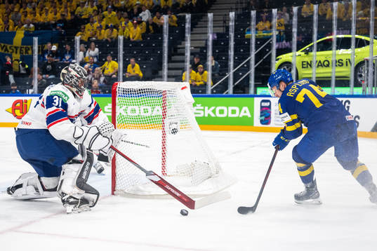 Goaltender Jonas Arntzen of Norway and Rasmus Asplund of