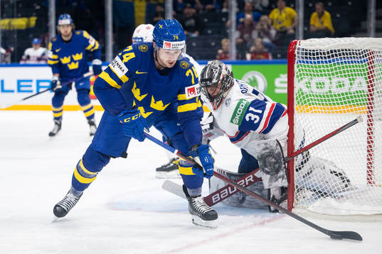 Rasmus Asplund of Sweden and goaltender Jonas Arntzen of