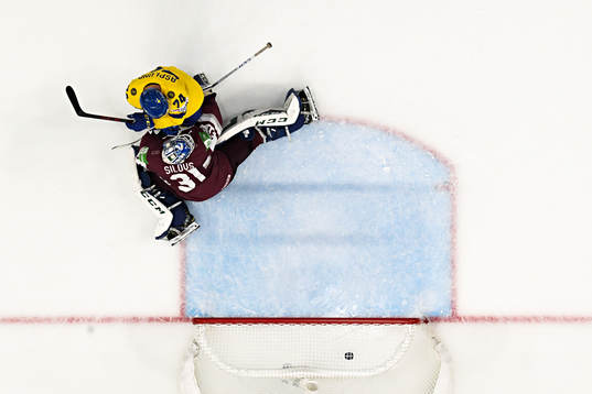Rasmus Asplund of Sweden and goaltender Arturs Silovs of
