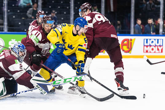 goaltender Arturs Silovs of Latvia and Kristaps Sotnieks