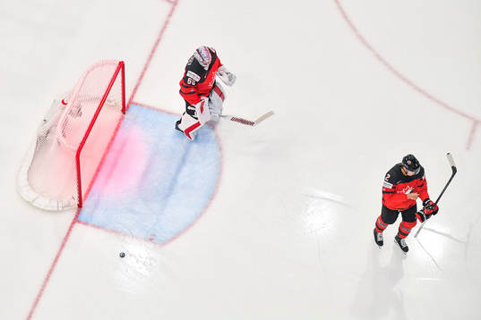 goaltender Chris Driedger and Zach Whitecloud look dejected