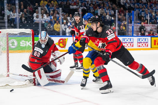 goaltender Chris Driedger and Ryan Graves of Canada defend