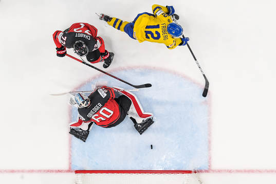 goaltender Chris Driedger and Thomas Chabot of Canada see