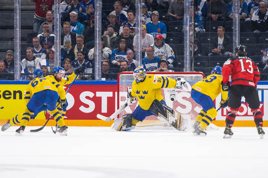 Drake Batherson of Canada scores 3-4 behind goaltender