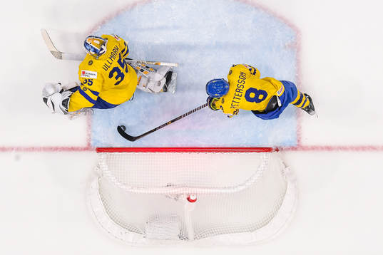 Marcus Pettersson and goaltender Linus Ullmark of Sweden