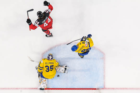 Marcus Pettersson and goaltender Linus Ullmark of Sweden
