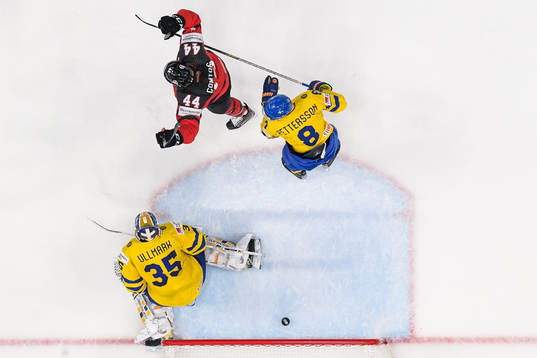 Marcus Pettersson and goaltender Linus Ullmark of Sweden