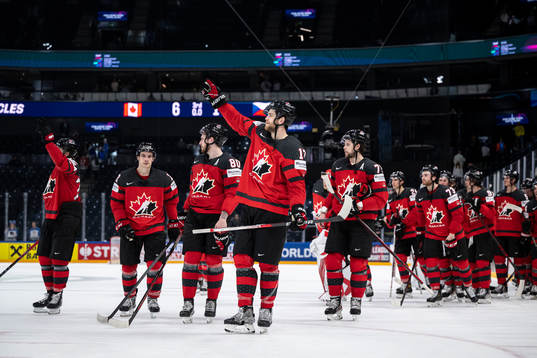Adam Lowry of Canada celebrate with teammates