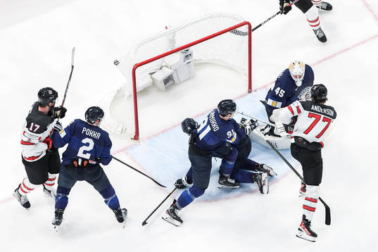 Zach Whitecloud of Canada (not in frame) scores 3-2 behind