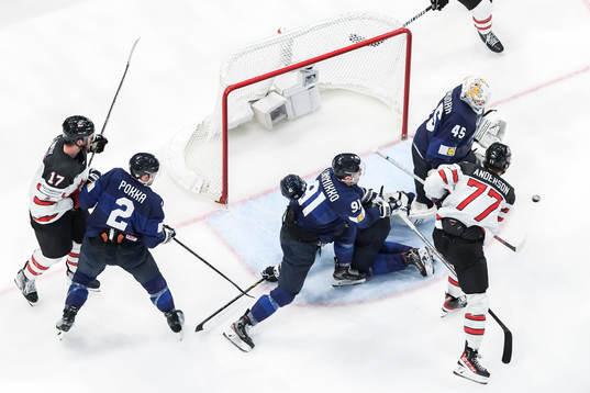 Zach Whitecloud of Canada (not in frame) scores 3-2 behind