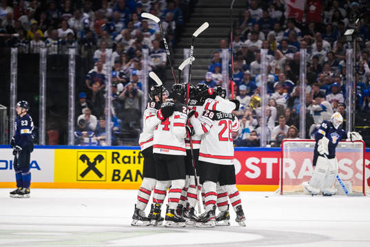 Max Comtois of Canada celebrates with team mates