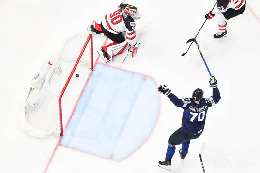 Goaltender Matt Tomkins of Canada looks dejected and Teemu