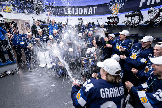 The team of Finland celebrate in the locker room