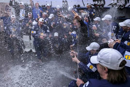 The team of Finland celebrate in the locker room