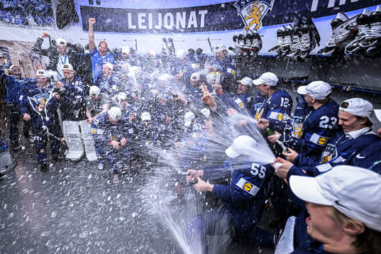 The team of Finland celebrate in the locker room
