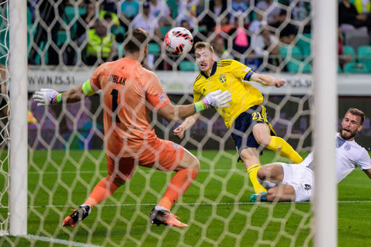Dejan Kulusevski of Sweden scores 0-2 behind goalkeeper Jan