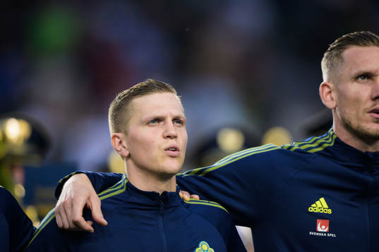 Joakim Nilsson and goalkeeper Robin Olsen of Sweden
