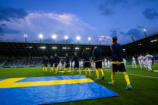 Players of Sweden and of Slovenia enter the pitch for the